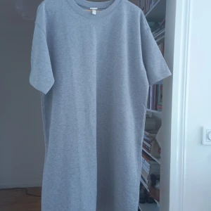Oanvänd Grå swetshirt tunika  - Gråmelerad swetshirt tunika frå  HQM, oanvänd. 