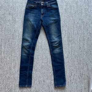 Nudie jeans  - Säljer ett par Nudie jeans med en riktigt snygg tvätt i modell skinny lin. Jeansen är i riktigt bra skick och har inte ett enda tecken på användning. Storleken på jeansen är W28/L32. Vid minsta fråga eller fundering är det bara att höra av sig!👍😁