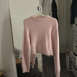 Rosa croppad tröja - Mysig rosa tröja, lite croppad, de står att strl är M men skulle säga att de passar xs-m beroende på hur man vill att den sitter. Den sitter nog lite tajt om man har storlek M. Tröjan är inte nopprig som de ser ut på bilden utan tröjan i sig är i ett lurvigt material. 