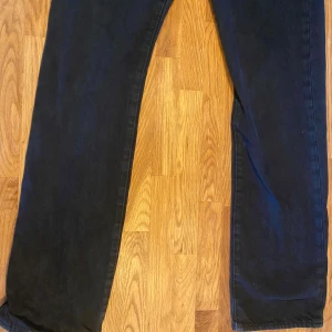 Svarta Levis 501 jeans - Snygga svarta Levis 501 jeans i klassisk design. De har en rak passform och är tillverkade i slitstarkt denim. Perfekta för en stilren look med den ikoniska Levis-lappen på baksidan. Pris kan diskuterats. Om du har några frågor kan du bara höra av dig.