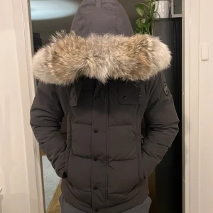 Canada goose Wyndham - Jätte fräsch Canada Goose Wyndham, storlek L men passar garanterat en M. Helt fräsch, fläckfri och rökfri. Kan gå med på en snabb affär. Pälsen är större en vanligt för att jag beställde den separat efter storlek.  
