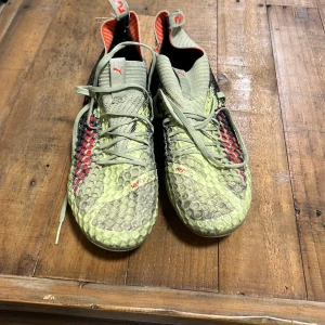 Puma fotbollsskor - Snygga fotbollsskor från Puma i grönt och svart med röda detaljer. De är använda och är i bra skick. Deras ordinarie pris är 3000 kr. Vid en snabb affär kan priset diskuteras