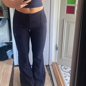 Kostymbyxor med utsvängda ben - Dessa kostymbyxor är använda fåtal gånger och är i väldigt bra skick! Benen har en utsvängd modell med sträck längst benen. 