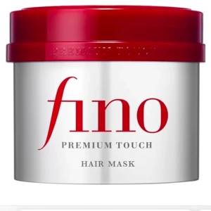 Fino Premium Touch Hair Mask - Fino Premium Touch Hair Mask är en lyxig hårinpackning som ger näring och glans till håret. Förpackningen är stilren med en röd lock och silverfärgad burk. Perfekt för att återfukta och stärka håret. Ej använd. 