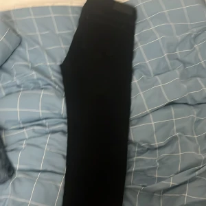 Svarta jeansbyxor - Säljer ett par svarta jeansbyxor i bra skick. De har en klassisk design med fem fickor och knappgylf. Perfekta för både vardag och fest!