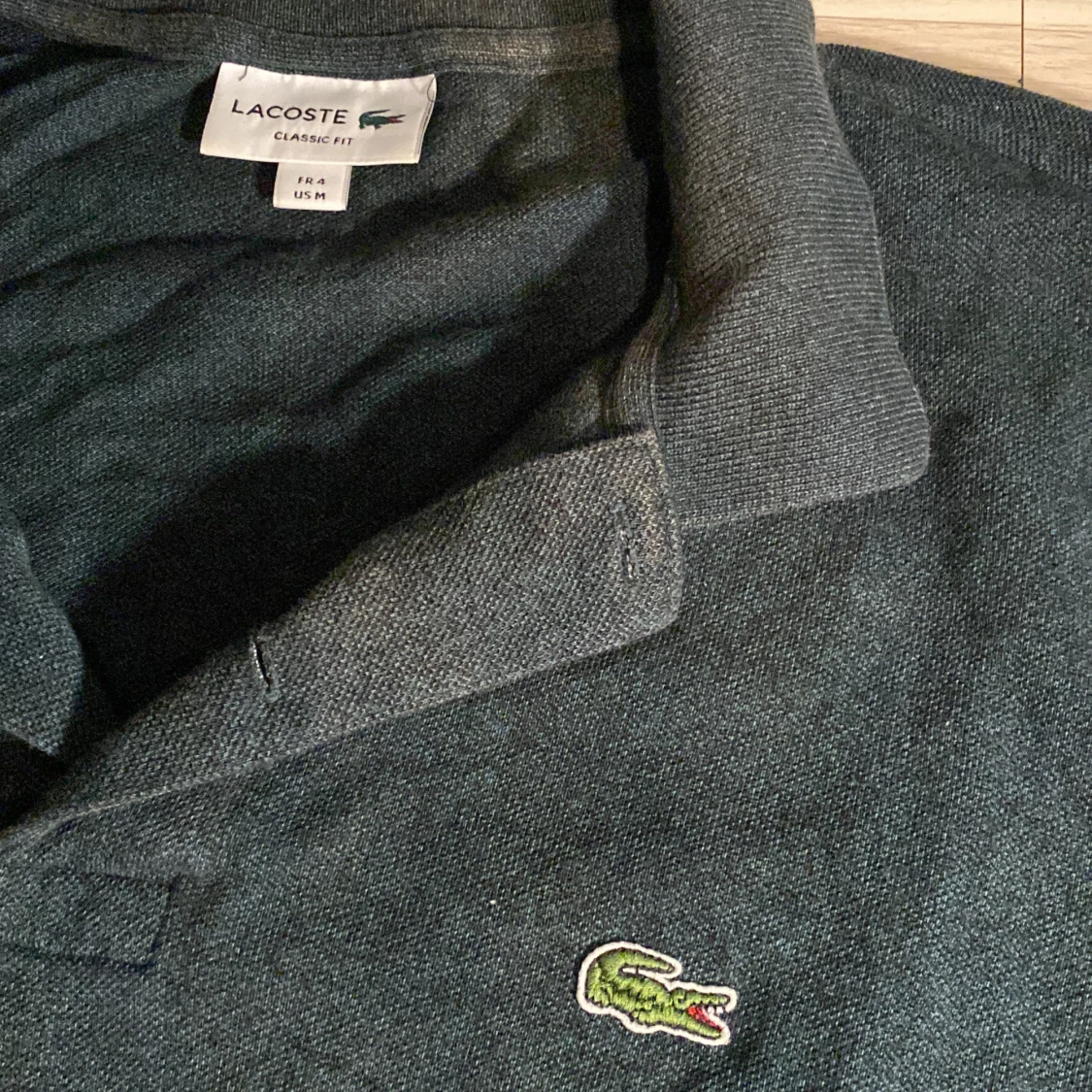 Mörkgrå pikétröja från Lacoste - 90