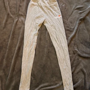 Grå leggings från Ellesse - Säljer ett par grå leggings från Ellesse i storlek EU 38 men är mest som xxs. De är superbekväma och perfekta för både träning och chill. Materialet är mjukt och stretchigt, vilket gör dem idealiska för en aktiv livsstil. De har en enkel design med Ellesse-loggan på sidan. Perfekta för höst och vår!