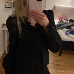 Svart blus men volang detaljer - Supersnygg svart blus med volang detaljer vid halsen och ärmsluten, och knappar framtill. Kommer tyvärr inte till användning och jättebra skick. Pris är diskuterbart💓