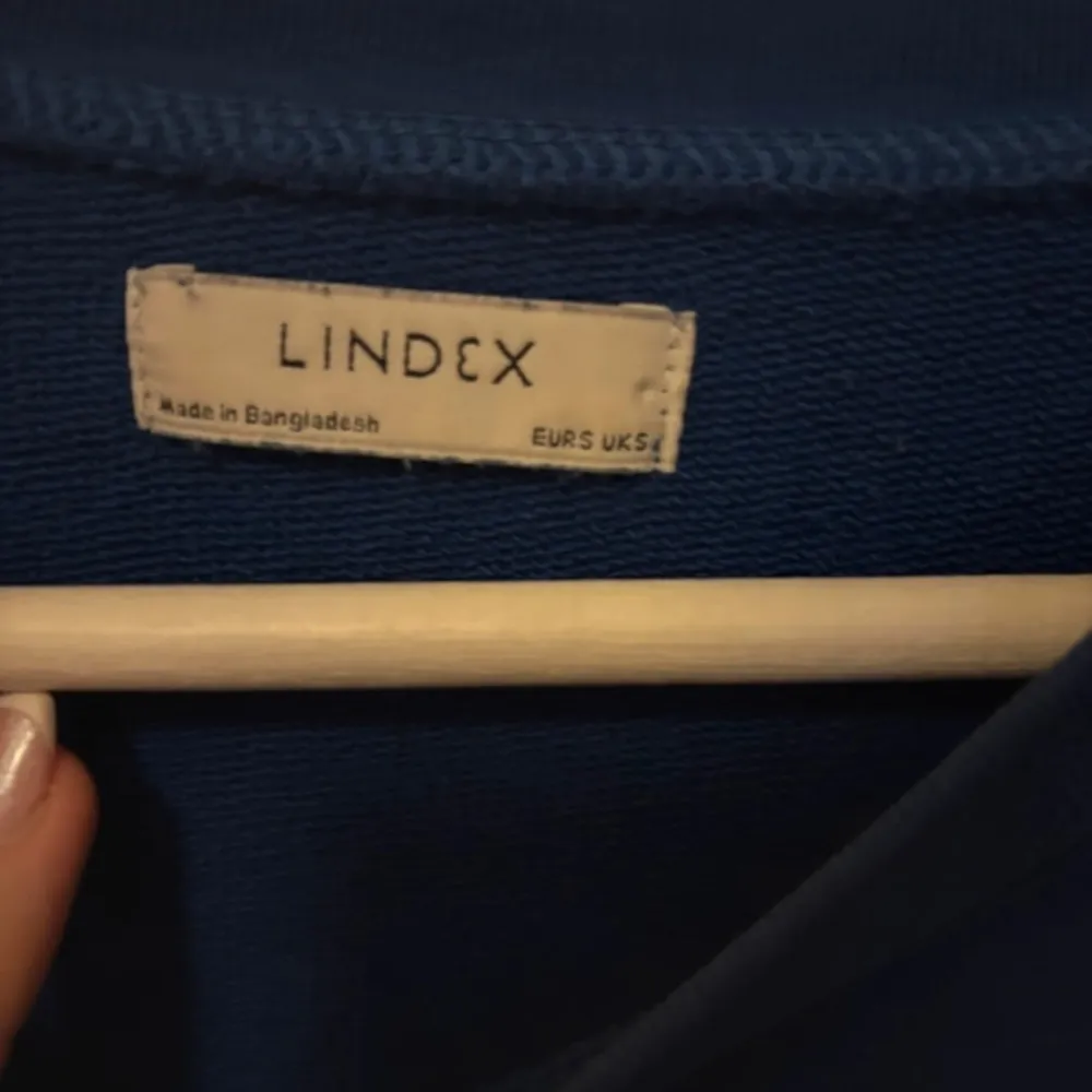 Säljer en blå tröja från Lindex i storlek S. Tröjan har en enkel design med långa ärmar och rund halsringning. Perfekt för en avslappnad stil.. Neuletakit & Villapaidat.