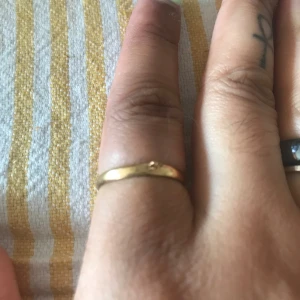 Guldig Ring  - Guldaktig Ring ej äkta, saknas berlock. Fint skick. Passar alla storlekar. Kan skickas emot frakt eller mötas upp i Hbg/Malmö. Endast pm vid köp. 