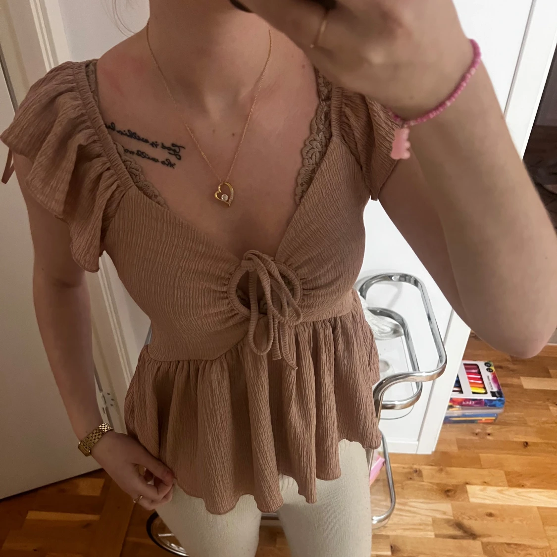 Beige topp med volangdetaljer