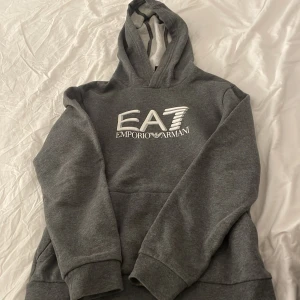 Ea7 Hoodie  - Den funkar till både tjejer och killar.  Storlek:150cm Den är för liten för mig Har andvänt denna Hoodie 4 gånger. Köpte för liten storlek. Stad: norrköping  Vid snabb köp kan priset diskuteras