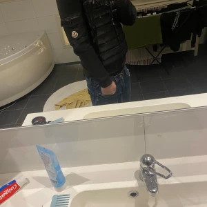 Moncler jacka - Säljer en stilren svart jacka från Moncler. Jackan har en quiltad design med dragkedja och en huva för extra skydd. Perfekt för kyligare dagar. Den är tjockare än vad den ser ut att vara! Den är inte äkta men den är väldigt stilren. Nfc funkar och Scan inuti jackan. 