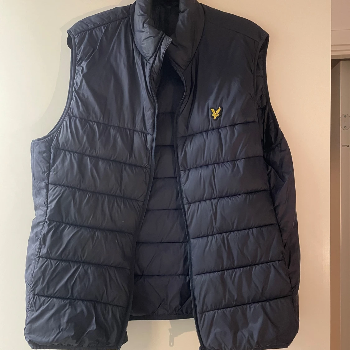 Mörkblå dunväst med broderad logga