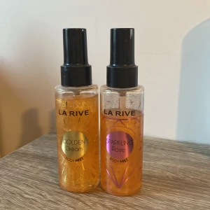 Body Mist från La Rive - Säljer två body mists från La Rive. Den ena heter Golden Dream och har en gyllene etikett, medan den andra heter Sparkling Rose med en rosa etikett. Båda flaskorna är 100 ml och har en praktisk sprayfunktion. Perfekta för att fräscha upp sig under dagen! Den guldiga har ca 95-90 ml kvar och den rosa har ca 70 ml kvar. De båda luktar jättegott!😍