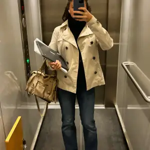 Säljer en snygg beige trenchcoat i mycket bra skick. Den har en klassisk dubbelknäppning och är perfekt för höst och vår. Jackan har långa ärmar och en stilren design som passar både till vardags och fest. ❤️❤️❤️