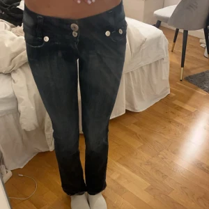 Mörkblå jeans från TBY - Säljer ett par snygga mörkblå jeans från TBY i storlek 28. De har en tight passform och är lågmidjade med två knappar och dragkedja fram. Jeansen har en broderad detalj på bakfickan och är perfekta för både vardag och fest. Passar bra till höst- och vintergarderoben! 🖤dem är korta i längden och därför är dem uppsprättade❣️ tvärsöver midjan 36cm, inneben 73cm och gren 17cm. Jag är 170cm lång om de hjälper som referens. Skriv om de finns några fler funderingar ❤️
