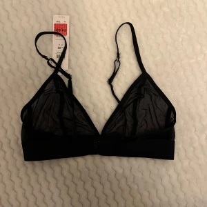 Svart mesh bralette - Säljer svart bralette i meshmaterial. Den är i nytt skick med etikett kvar. 