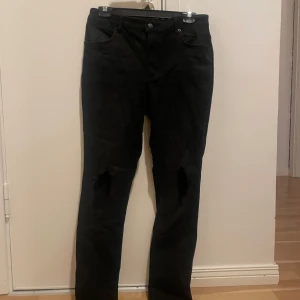 Svarta jeans med slitningar - Fina sköna svarta jeans med hål i knäna