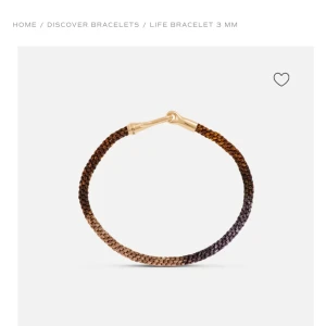 Ole lynggaard Life Bracelet 3 mm - Elegant armband med en flätad design i en gradient av bruna och svarta toner. Armbandet har en stilren guldfärgad låsdetalj som ger en lyxig touch. Perfekt för att komplettera din stil med en subtil men sofistikerad accessoar. Nypris 8200kr