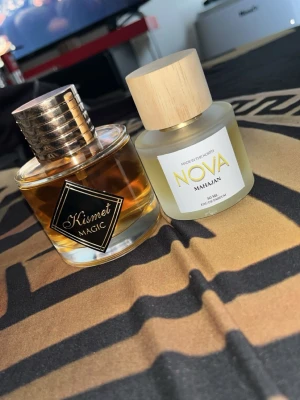 2 Nya Parfymer - Säljer två unisexparfymer i toppskick, båda är knappt använda och i princip fulla. Ingen box ingår.  Maison Alhambra Kismet Magic 100 ml – inspirerad av Angels’ Share. Varm och söt doft med noter av konjak, kanel, tonkaböna, vanilj, pralin och sandelträ.  Nova Scents Mahajan 50 ml – inspirerad av Parfums de Marly Oajan. Kryddig och söt doft med honung, kanel, osmanthus, labdanum, vanilj och benzoin.  Säljs till ett bra pris. Skriv vid intresse eller om du har frågor!