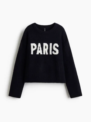 paris stickad tröja - Mörkblå stickad tröja med ett vitt paris tryck på framsidan. Skön och snygg tröja!! Pris kan alltid diskuteras eftersom att tröjan inte kommer till användning.