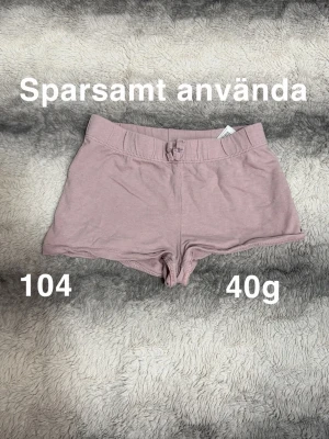 Lila shorts med knyt - Säljer ett par lila shorts med knyt i midjan. De har en enkel och clean design med korta ben. Perfekta för varma dagar eller som ett chill plagg hemma.🌸 Sparsamt använda. Storlek 104