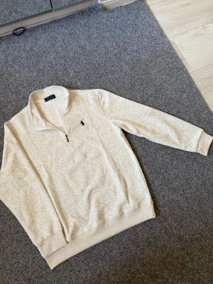 Ralph Lauren light gray quarter zip sweater - Size M, true to size. Very comfortable and fits perfectly.
