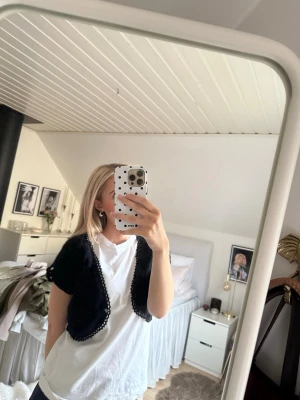 Svart bolero från Karen Millen - Säljer en svart bolero från Karen Millen med korta ärmar, virkad kant och små ”diamanter”. Aldrig använd, därmed i nyskick. Storlek s men passar även mig som har storlek xs🫶🏻