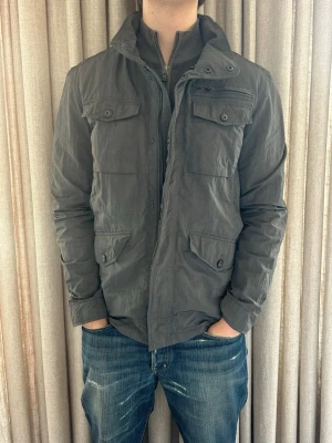 Celio field jacket grå - M - Fint skick, inga defekter. Modellen på bilden är ca 180 cm. Om du undrar över något tveka då inte på att höra av dig!