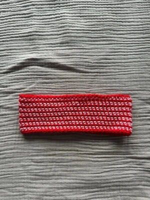 Virkat hårband - Egentillverkat virkat hårband i rött och rosa garn. Tvättas i 30 grader