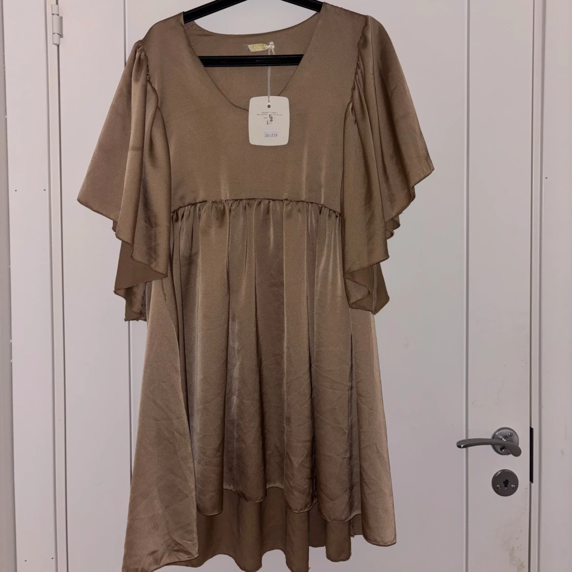 Beige omlottklänning med volang