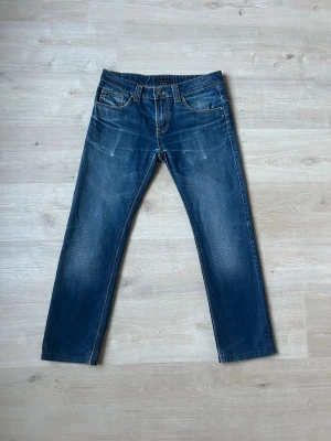 Blåa Dry Japan Nudie Jeans Slim Jim Storlek W32 L33 - Fina Nudie Jeans i blå färg. Jeansen är i mycket bra skick och sparsamt använda. |  Äkta som allt annat jag säljer! ✅ |  Storlek: W32 L33 | Skick: Mycket Bra Skick | Färg: Blå | Märke: Nudie | Modell: Jeans |  Hör gärna av dig vid frågor så svarar jag så fort jag kan! 😁 |  (SKU - 125)