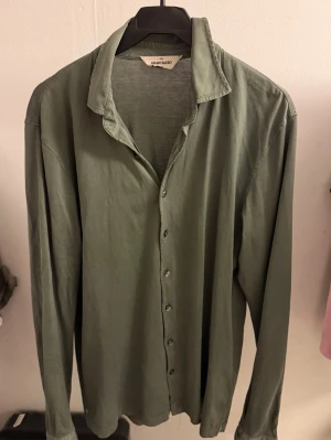 Gran Sasso limited edition skjorta  - Snygg grön skjorta från Gran Sasso med klassisk krage och knappar framtill. Skjortan är långärmad och har en relaxed passform som är perfekt för en chill look. Materialet känns mjukt och lätt, vilket gör den bekväm att bära hela dagen.