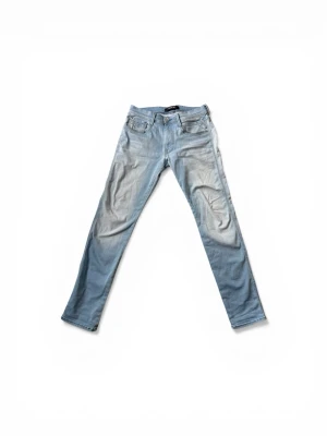 Replay, Ljusblå slim/straight fit jeans - Snygga ljusblå jeans i slim/straight fit-modell med klassisk femficksdesign och diskret slitning framtill. Jeansen har normal midja och raka ben, perfekta för en avslappnad stil. Tillverkade i mjuk denim med lite stretch för extra komfort. Hör av er vid funderingar eller bilder! 