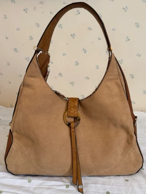 Vintage mocka axelväska  - Snygg beige/brun River Island handväska med guldiga detaljer. Rymmer mycket. 34x20x15cm. 