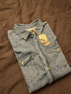 Nudie jeans skjorta - Helt oanvänd ny Nudie Jeans skjorta. Nypriset är 1499kr. Riktigt fin skjorta och inga flaws. Passformen är true to size (Medium). Dimensionerna är; Axelbredd 47cm, Längd 65cm, armlängd 64cm. Hör av vid funderingar kring priset eller varan