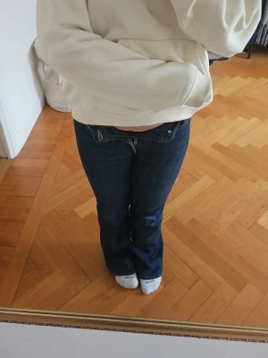 Acne studios jeans - Säljer ett par mörkblå bootcut jeans som e mid waist. Dem har smä slitningar längst ner från att dem har varit för långa, dem e från acne studios. 