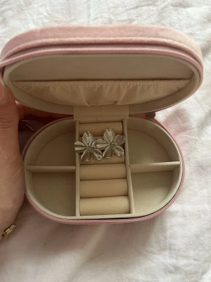 Silvriga blomformade örhängen - Säljer ett par silvriga örhängen i form av blommor med fem blad. Örhängena har en glansig finish och detaljerade räfflor på varje blad som ger ett snyggt djup. Perfekta för dig som vill ha ett statement-smycke med unik design.