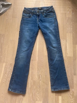Blå bootcut jeans från LTb - Snygga blå bootcut jeans från LTB. Har använt dom ganska ofta därför lite sönder ( se bild ) men allmänt väldigt bra skick 
