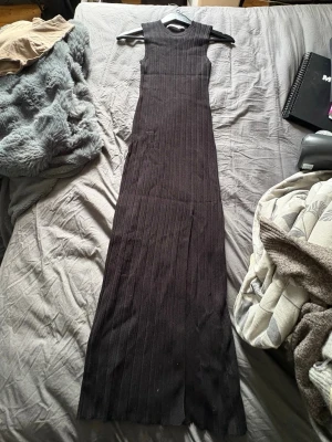 Svart ribbad långklänning Bershka - Svart långklänning från Bershka i ribbat material.  Använd kanske ett fåtal gånger. Perfekt för dig som gillar en stilren och enkel look.