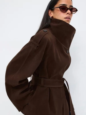 Mörkbrun trenchcoat med bälte Ginatricot - Slutsåld mörkbrun trenchcoat med hög krage och stora knappar från Ginatricot. Helt ny, använd bara en gång! Jackan har ett matchande midjebälte och axelklaffar för en klassisk look. Tillverkad i ett mjukt, mockaliknande material som ger en lyxig känsla. Perfekt för dig som vill ha en trendig och tidlös jacka. Helt slutsåld, pris kan diskuteras vid behov. 