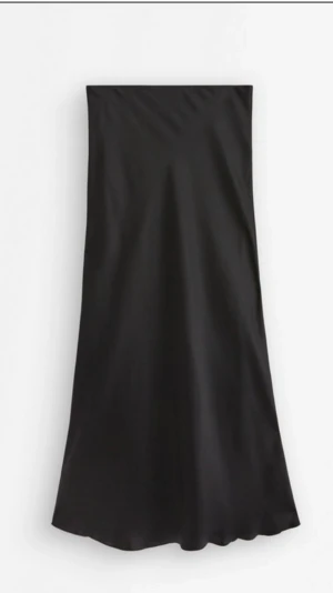 Svart långkjol i satin - En stilren svart långkjol i glansigt satinmaterial. Kjolen har en rak och enkel design som faller snyggt längs benen. Perfekt för dig som gillar minimalistisk och tidlös stil.