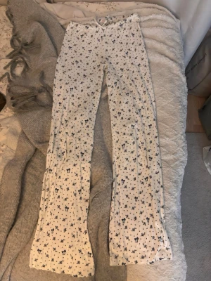 Vita pyjamasbyxor - Mysiga vita pyjamasbyxor med blått småblommigt och kattmönster. Har en fläck på baksidan kan försöka få bort!