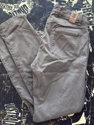 Hansen & Jacob byxor  - Snygga grå manchesterbyxor från WOS med smal passform och klassiska bakfickor. Byxorna har bälteshällor och en stilren look som passar perfekt till en trendig vardagsstil. Mjukt manchestertyg ger en skön känsla och cool vibe.