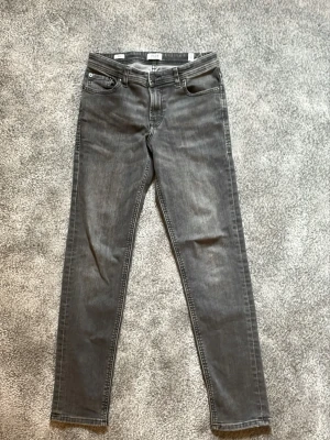 Gråa jeans från Jack & Jones  - Säljer ett par gråa jeans från Jack&Jones. helt oanvända