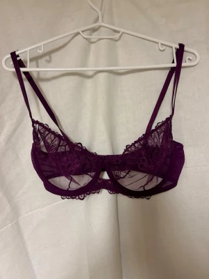 Lila spets-bh  - Säljer den pga att jag inte använder den😔. Kuporna är genomskinliga med broderat mönster och har bygel för extra stöd!💜💜. ⚠️Osäker på om jag valde rätt storlek, så skriv gärna och fråga om mått!