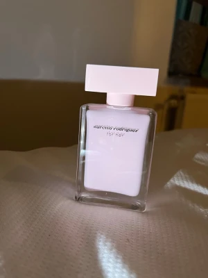 Narciso Rodriguez For Her parfym 50ml - Säljer en elegant parfym från Narciso Rodriguez, For Her, i en stilren ljusrosa glasflaska med matchande rektangulärt lock. Flaskan rymmer 50 ml och har endast testats! Så mer eller mindre helt ny.