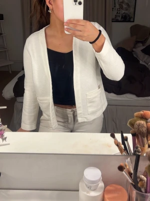 Vit öppen kofta med fickor - Snygg vit öppen kofta med två framfickor och rak passform. Köpt på Sellpy men kommer ifrån Gina. Perfekt att ha till jeans eller kjol nu till sommarn  
