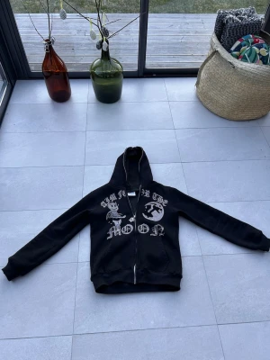 Svart hoodie med tryck och dragkedja - Säljer en svart aim for the moon hoodie i storlek xs. Den är i väldigt gott skick och är inte använd så mycket.  